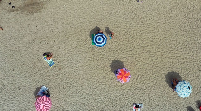 Kuşadası'nda denize sosyal mesafe kurallarına uyularak giriliyor